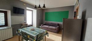 a living room with a table and a couch at Re Di Coppe in Torre Boldone