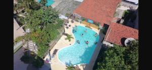 an overhead view of a swimming pool in a resort at Suíte 1, Caminho do Mirante in Iguaba Grande