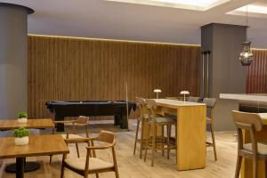 a restaurant with a pool table and a piano at Fiesta Inn Monterrey Valle in Monterrey