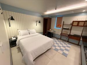 En eller flere senge i et værelse på 그랑메종바오밥호텔