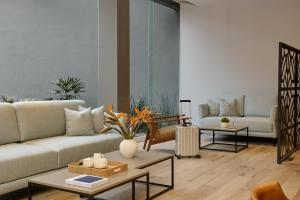 a living room with a couch and a table at Fiesta Inn Monterrey Valle in Monterrey