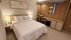 En eller flere senge i et værelse på 그랑메종바오밥호텔