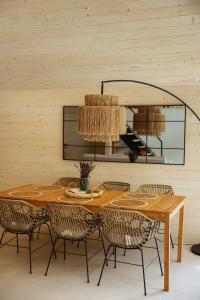 a dining room table with chairs and a chandelier at Villa Lis in Ivano-Frankivsk