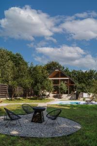 a group of chairs and a table in a yard at Villa Lis in Ivano-Frankivsk