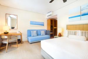 爱妮岛Huni Lio的一间卧室，配有一张床、一张桌子和一把椅子 更多29张照片