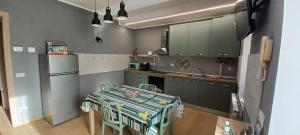 a kitchen with a table with chairs and a refrigerator at Re Di Coppe in Torre Boldone