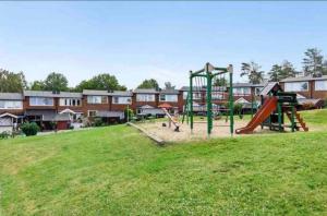 a park with a playground with a slide at Rymligt och härligt radhus i Göteborg in Gothenburg