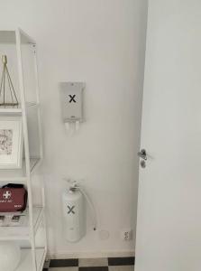 a white bathroom with a white door and a shelf at Rymligt och härligt radhus i Göteborg in Gothenburg +21 photos