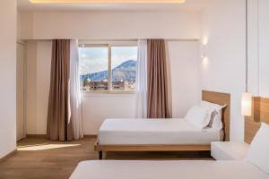 a hotel room with two beds and a window at Skyline Boutique Hotel in Palermo
