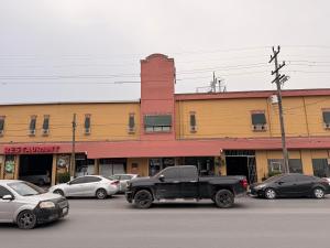 a truck parked in a parking lot in front of a building at Hotel Mirage Diagonal in Matamoros