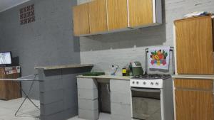 a kitchen with a stove and a counter top at KitNet a caminho da ILHA DO MEL in Pontal do Paraná