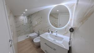 a white bathroom with a sink and a mirror at Luxury Home Airport in Naples +34 photos