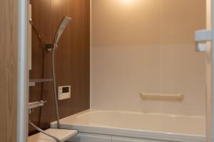 a shower with a glass door in a bathroom at 久乃家 in Matsue