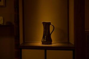 a vase sitting on a shelf in a room at 久乃家 in Matsue