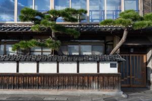 a pine tree on the side of a building at 久乃家 in Matsue