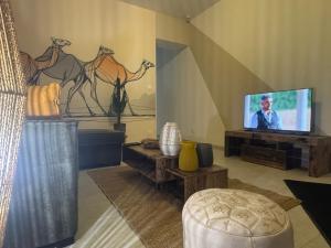 a living room with a flat screen tv on a wall at Maison Nomade in Feignies
