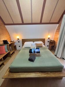 een slaapkamer met een groot groen bed in een kamer bij Kubotique Beachfront Staycation in El Nido +14 foto's