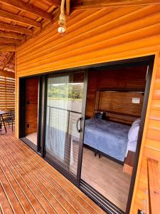 a bedroom on the deck of a house at Pousada reserva do J in Serra Negra