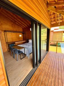 a screened in porch with a table and a bed at Pousada reserva do J in Serra Negra