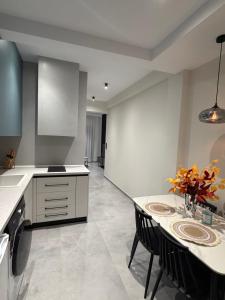 a kitchen with a table with chairs and a counter at Bright 7th floor Studio-Near Center of Xanthi in Xanthi