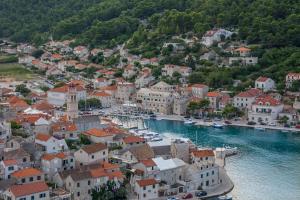 an aerial view of a town with boats in the water at Rooms Blanc in Pučišća