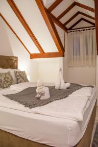 a bed with two stuffed animals on top of it at Rooms Bed and Breakfast Blanc in Pučišća +123 photos