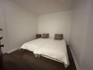 a bedroom with a white bed with two pillows on it at New Management - Collingwood Getaway in Collingwood