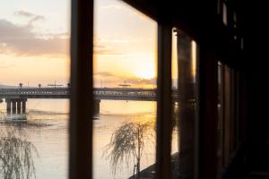 a view of a bridge from a window at 久乃家 in Matsue +26 photos