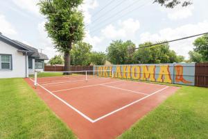 a tennis court in a yard with a mural at 5 Beds Downtown OKC - Pickleball, Hot Tub, Firepit, GameRoom in Oklahoma City