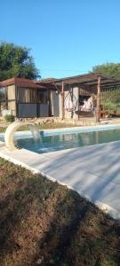 einem Pool mit Wasserrutsche vor einem Haus in der Unterkunft Lo de Nor - Refugio de Montaña in San Antonio de Arredondo + 24 Fotos