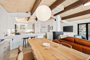 a kitchen and a living room with a wooden table at Shadow Mountain 20 in Aspen