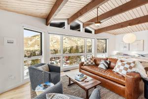 a living room with a brown leather couch and chairs at Shadow Mountain 20 in Aspen