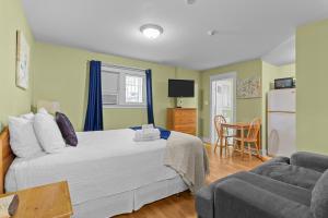 a bedroom with a bed and a couch at Cozy Manor Studio Parking WiFi in St. John's