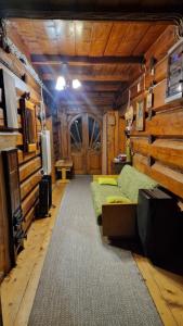 Zimmer mit 2 Sofas in einem Zimmer mit Holzwänden in der Unterkunft Stara chałupa in Murzasichle