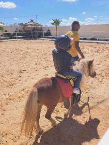 a man and a child riding on a horse at Forsen Kerkouen in Kerkouene