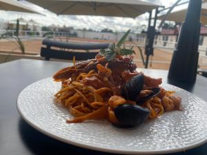 a white plate of pasta on a table at Forsen Kerkouen in Kerkouene +13 photos