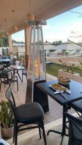 a fire pit on a patio with tables and chairs at Forsen Kerkouen in Kerkouene