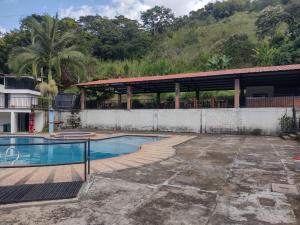 een zwembad voor een gebouw bij Finca Hotel Rancho Cattleya in Estación El Salto