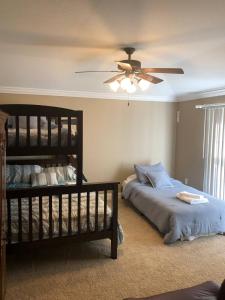 a bedroom with two beds and a ceiling fan at Splash in the Smokys ! in Sevierville +31 photos