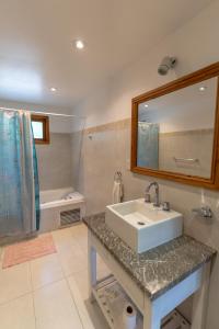 a bathroom with a sink and a mirror and a tub at Complejo Pelicano Chapadmalal in Chapadmalal +111 photos