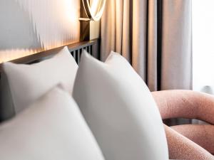 a close up of a couch with pillows at Tribe Amsterdam City in Amsterdam +67 photos