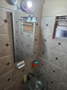 a bathroom with a sink and a mirror at Central Urbano CDE in Ciudad del Este +47 photos