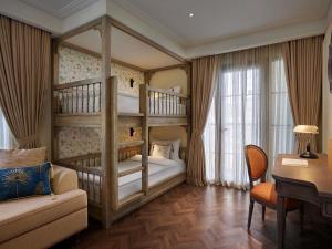 a bedroom with two bunk beds and a desk at Mercure Dalat Resort in Da Lat +126 photos