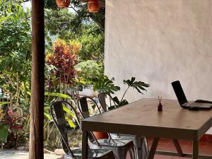 a table with a laptop sitting on top of it at Runa Barichara in Barichara