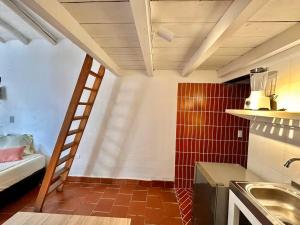 a kitchen with a ladder in a small room at Runa Barichara in Barichara +67 photos