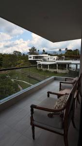 a balcony with two beds and a view of a building at Apartamento Campestre 6 Pax in Armenia +31 photos