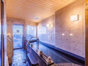 an indoor swimming pool in a room with a pool at APA Hotel Asakusa Kuramae in Tokyo