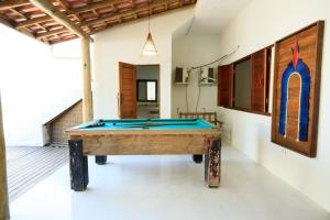 a pool table in the middle of a room at Casa George Trancoso in Trancoso