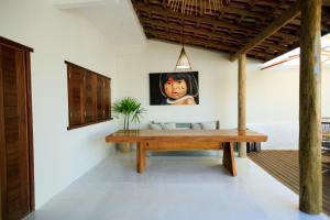 a room with a table and a picture of a child at Casa George Trancoso in Trancoso