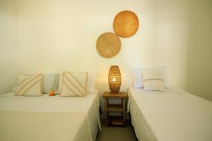 two beds sitting next to each other in a room at Casa George Trancoso in Trancoso +48 photos